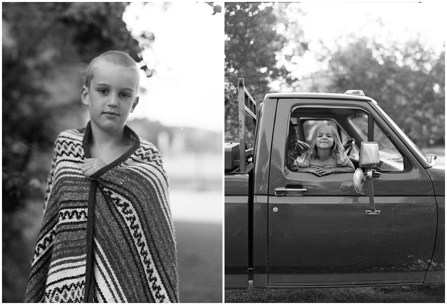 Black and white film of kids playing in old ford pickup truck.