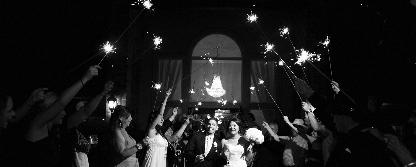 Dallas photographer captures couple leaving grand sparkler exit.